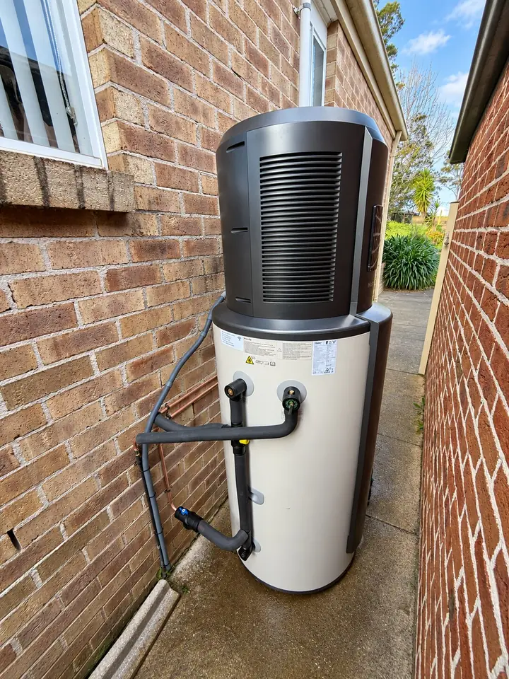 Heat pump hot water system installed in a side passage with insulated pipe connections, NSW